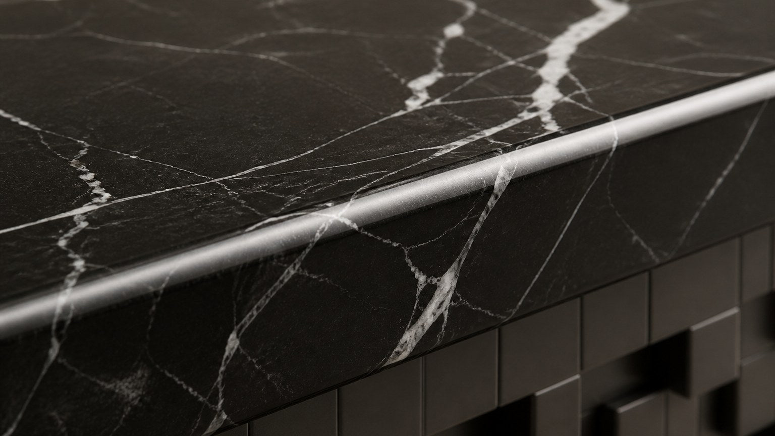 Black marble bench Samt 180, deep black with white veining, on a pale stone floor.
