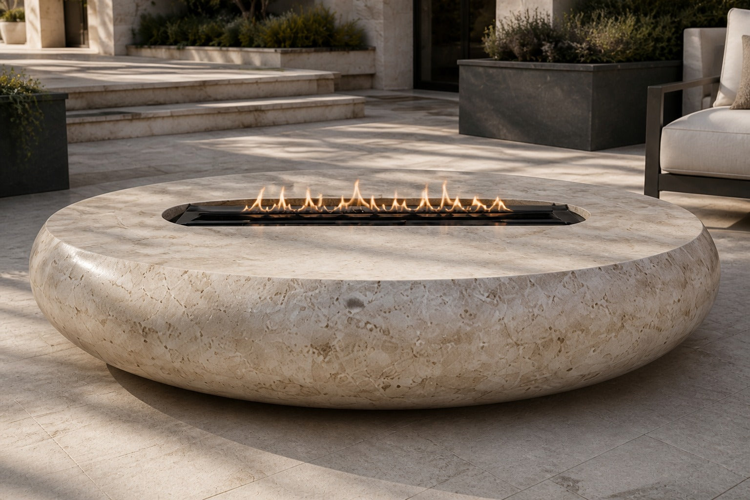 Pale fossil travertine fire bowl Bruna Ø180, pale cream with dense fossil shell, on a pale stone floor.