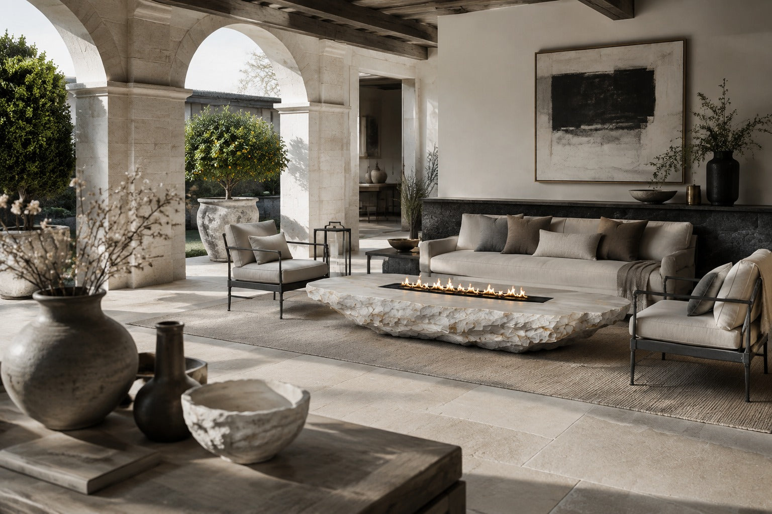 White quartzite fire table Himara 220, bright white with warm inclusions, on a pale stone floor.
