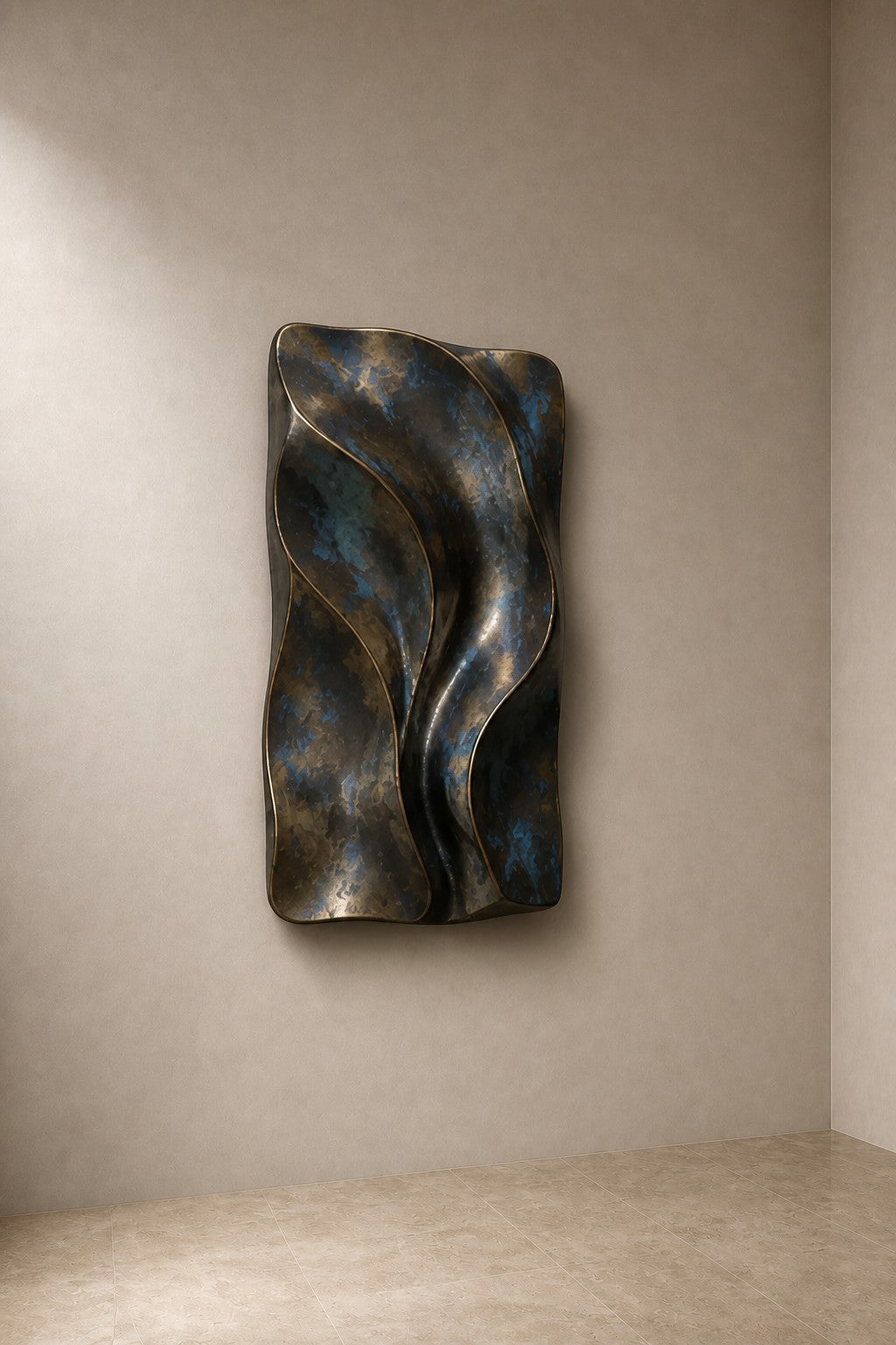 Antique bronze bronze wall sculpture Cuna, nested open ovals cradling a polished core, on a plaster wall.