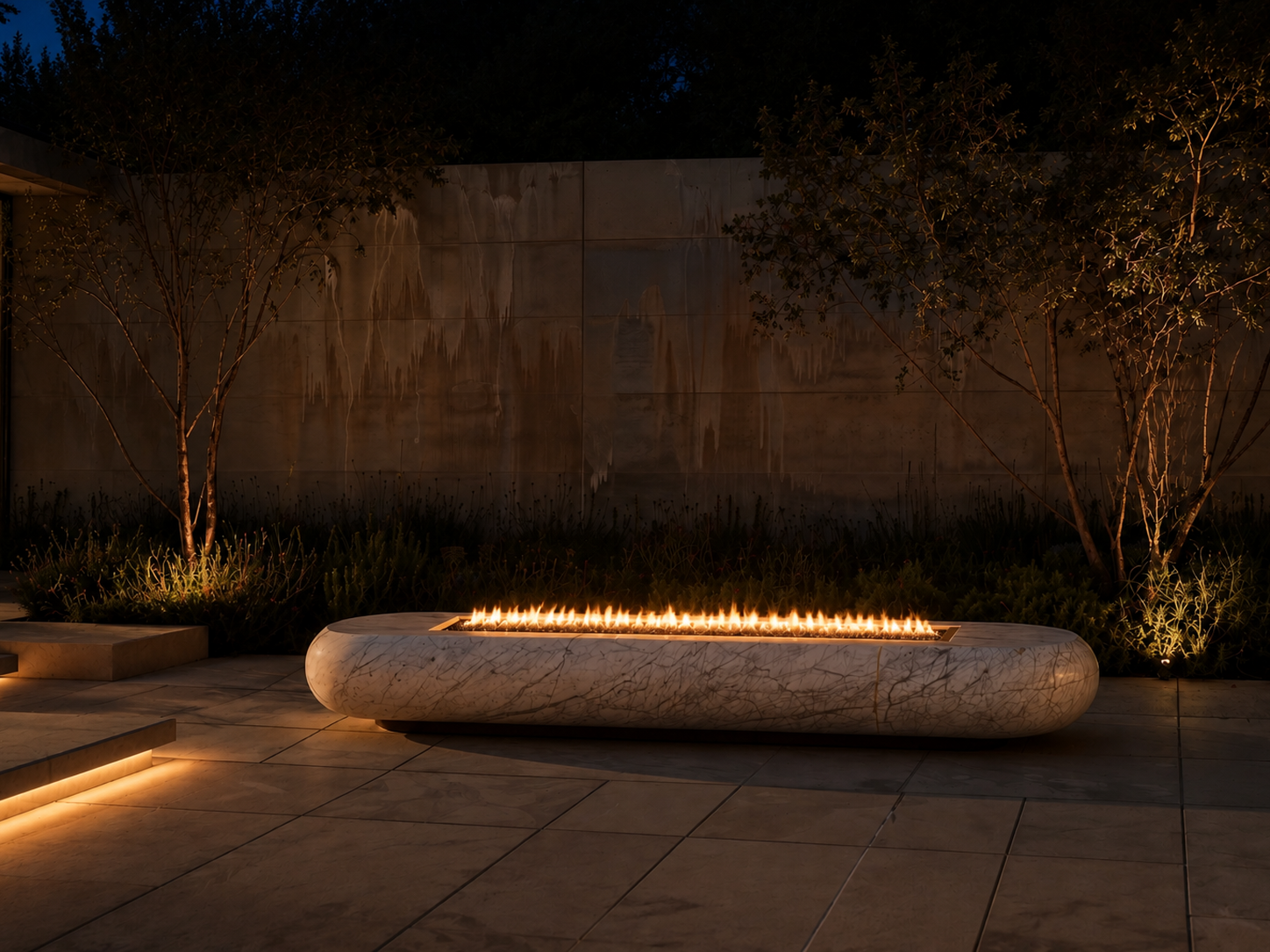 Lattea white marble fireplace by 1-OPH lit at night