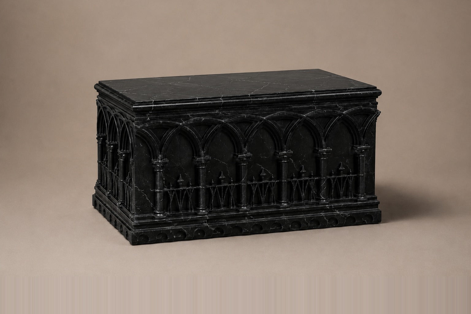 Low wide black Nero Marquina marble base carved with an arcade of pointed Gothic arches on colonnettes.