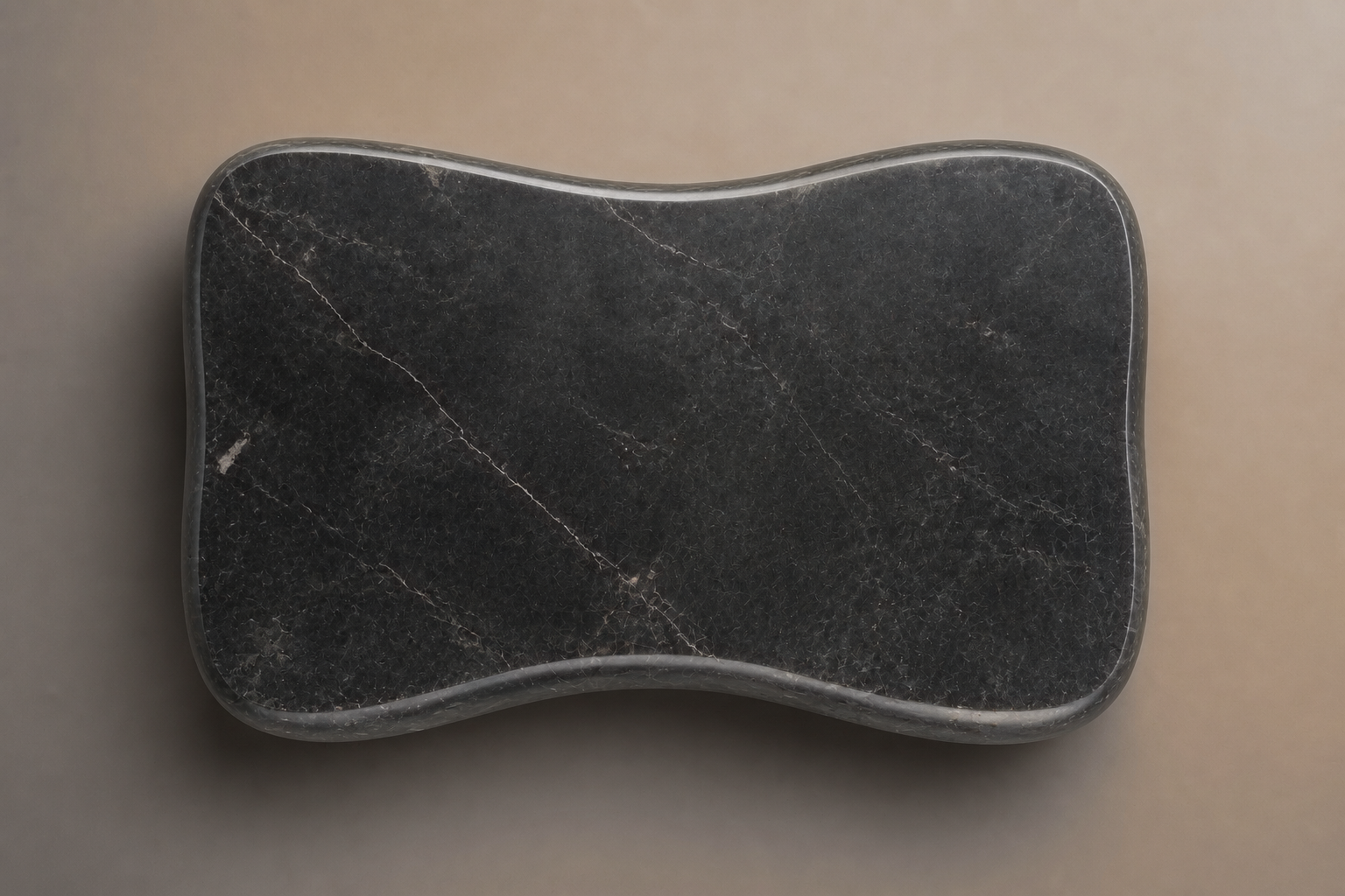 Convex Pillow Base Curved black marble plinth base by 1-OPH, overhead view