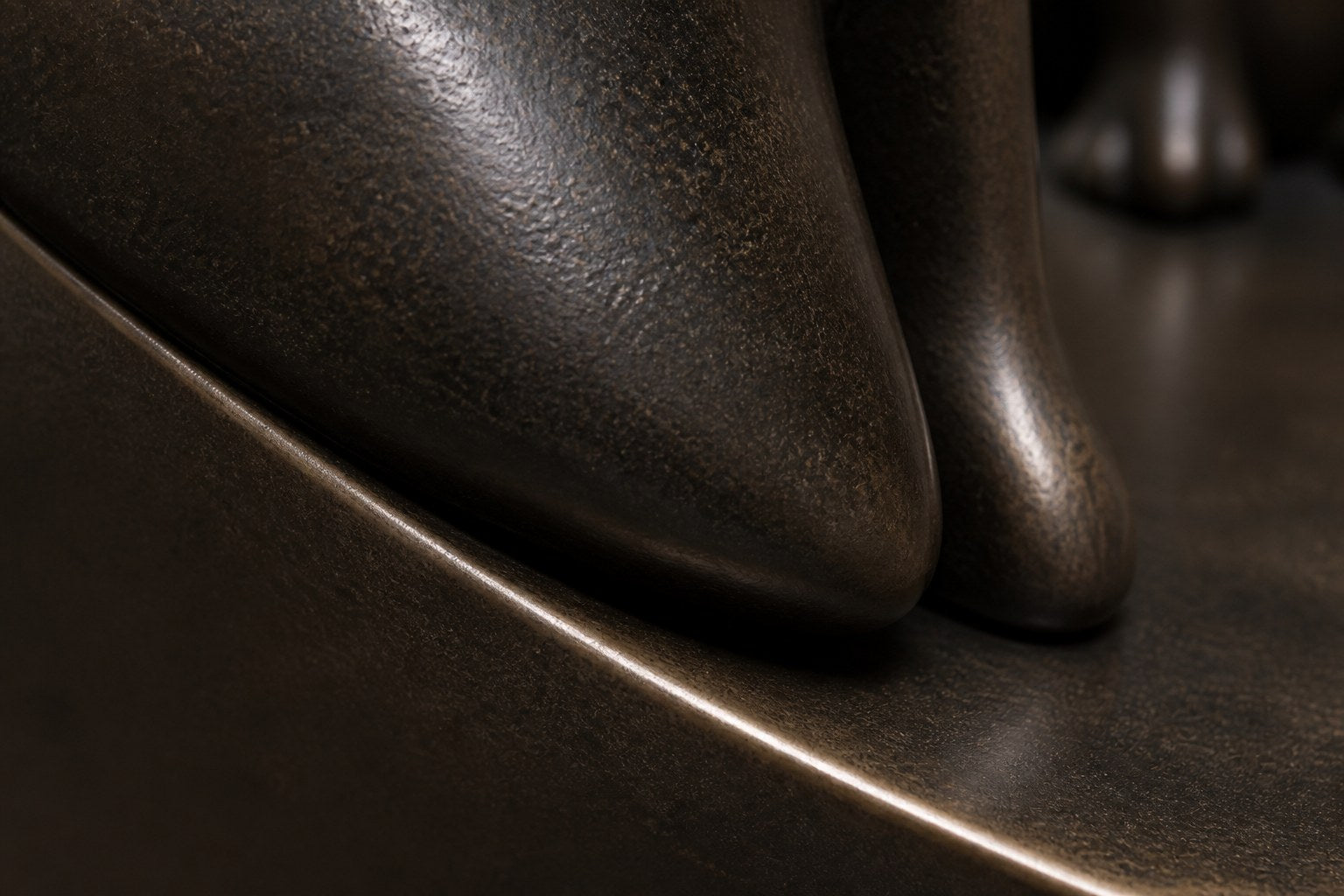 Dark bronze crescent sculpture Quebrada balanced on its curve, three seated forms at the high end and one walking down the fall.