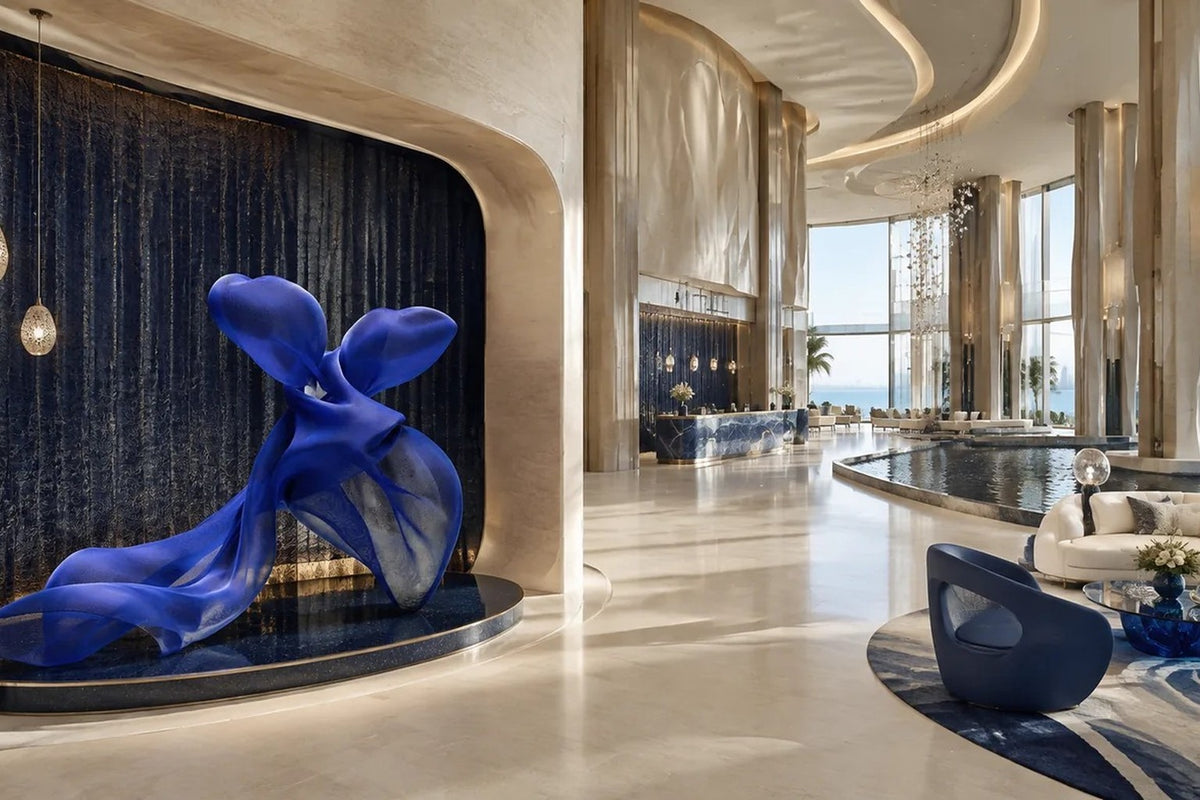 Cobalt blue woven wire sculpture Shaula, a draped form with two raised lobes and a long sweep trailing to the floor.