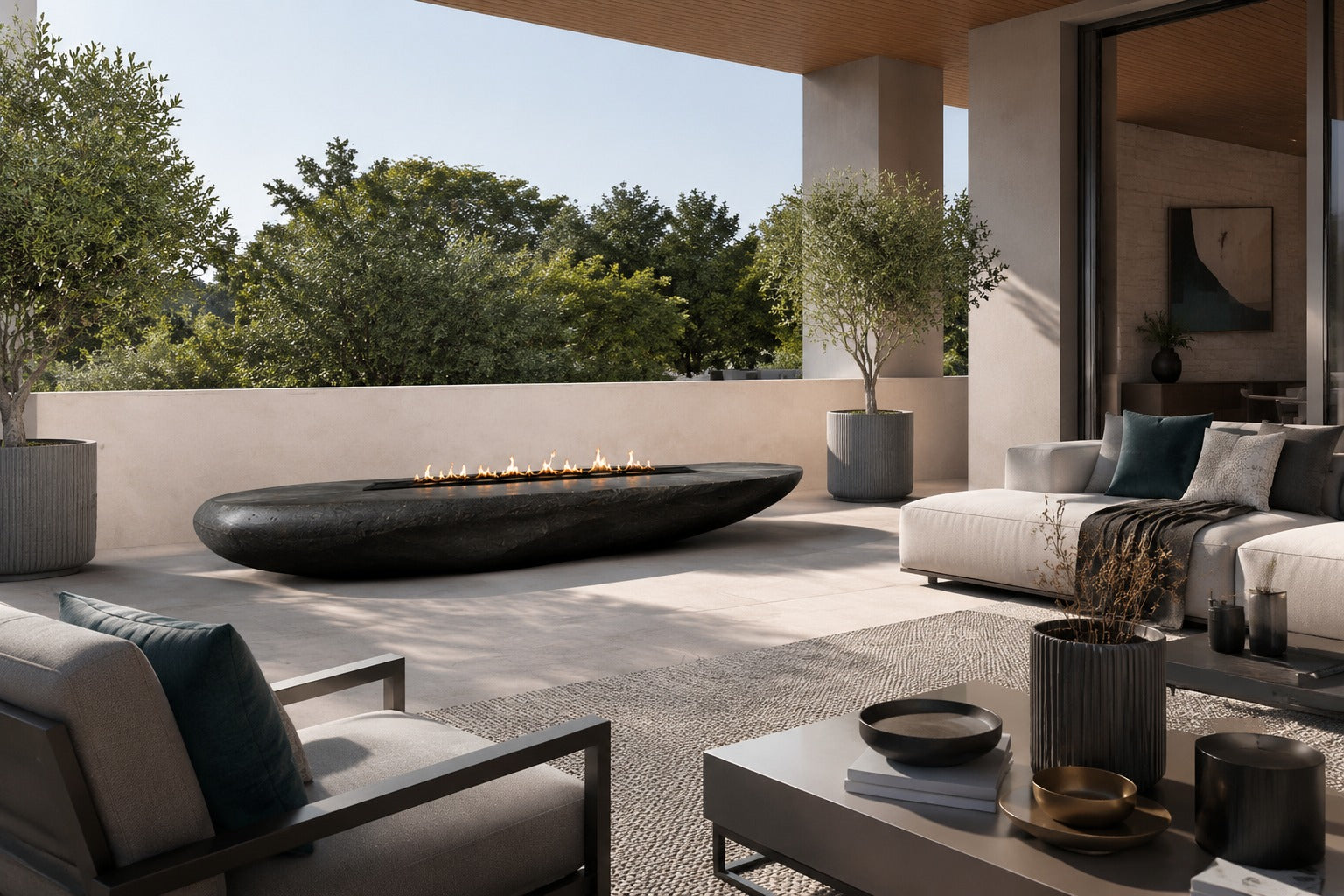 Charcoal-bronze stone fire table Suiran 220, charcoal with a warm bronze cast, on a pale stone floor.
