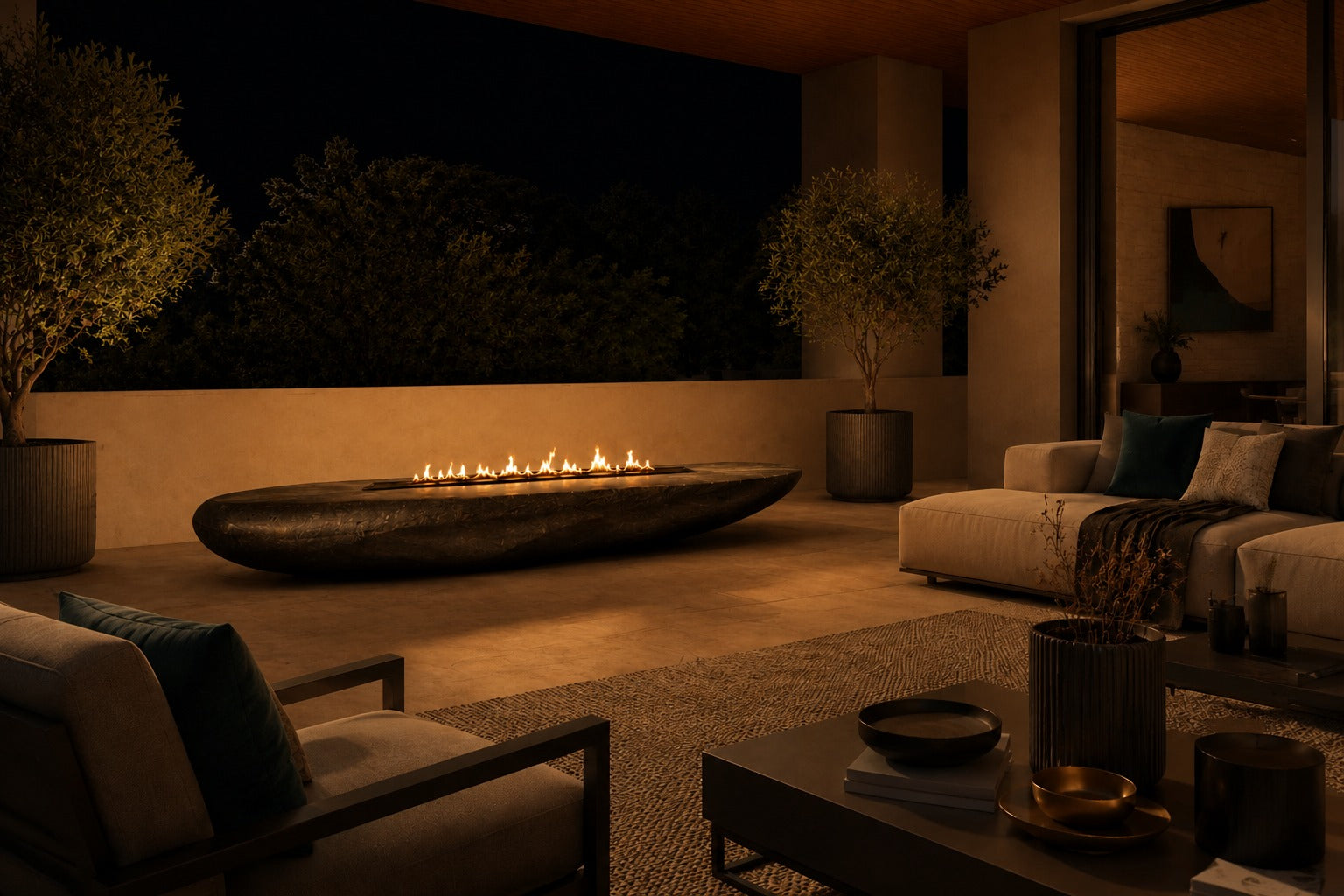 Charcoal-bronze stone fire table Suiran 220, charcoal with a warm bronze cast, on a pale stone floor.