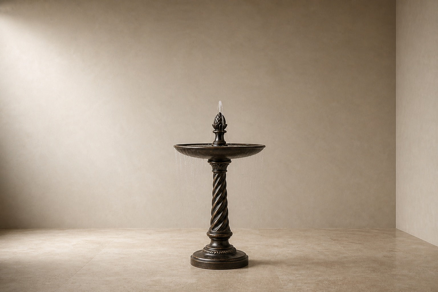 Stone pedestal fountain Wayrana Ø65, dark bronze, on a pale stone floor.