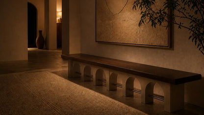 Stone bench Descanso 240, warm walnut seat, pale stone arcade, on a pale stone floor.