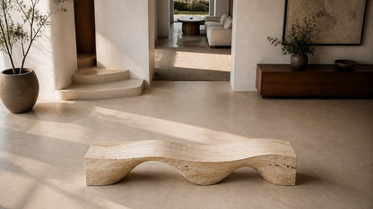 Travertine bench Hudu 180, warm cream with open pitting, on a pale stone floor.