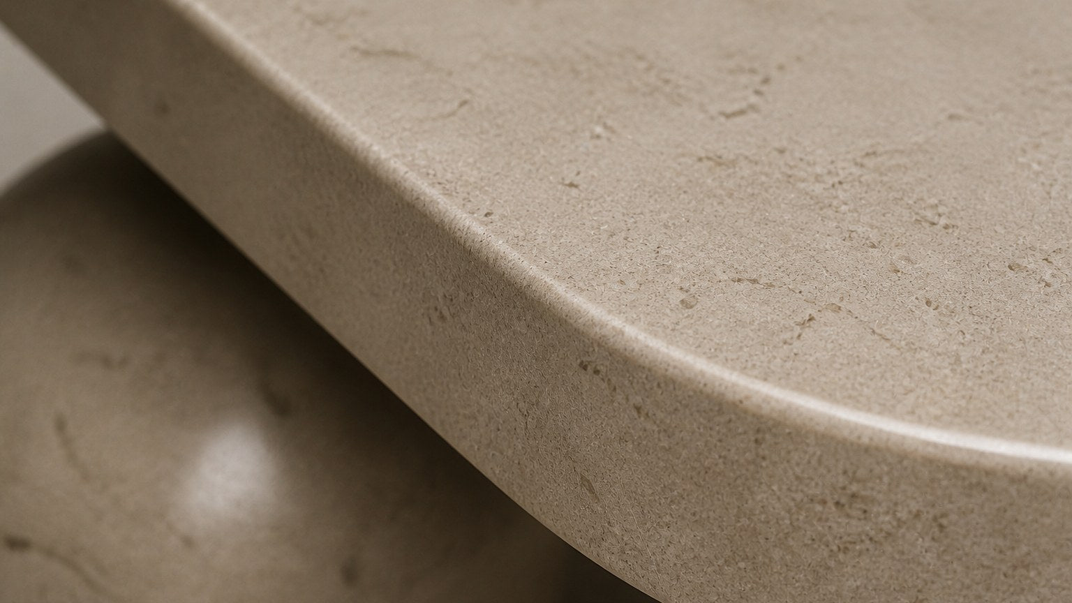 Cream stone bench Quieto 180, warm cream, blackened cone, on a pale stone floor.