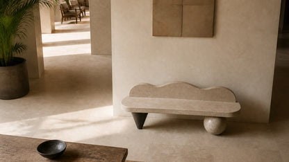Cream stone bench Quieto 180, warm cream, blackened cone, on a pale stone floor.