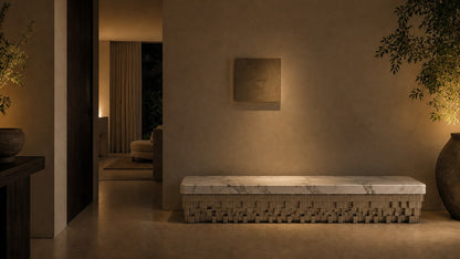White marble bench Sabat 180, white with grey veining, pale base, on a pale stone floor.