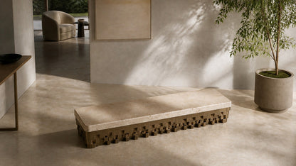 Travertine bench Sukoon 180, warm cream seat, olive-bronze base, on a pale stone floor.