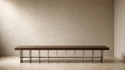 Timber and steel bench Tomari 240, dark walnut seat, brushed steel legs, on a pale stone floor.