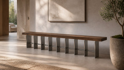 Timber and steel bench Tomari 240, dark walnut seat, brushed steel legs, on a pale stone floor.