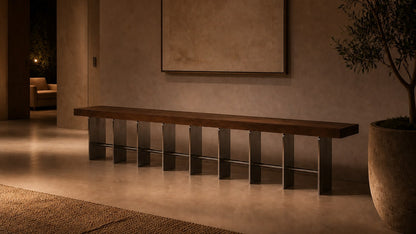 Timber and steel bench Tomari 240, dark walnut seat, brushed steel legs, on a pale stone floor.