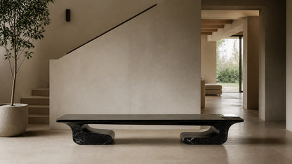 Black stone bench Yutori 180, deep black with white veining, on a pale stone floor.