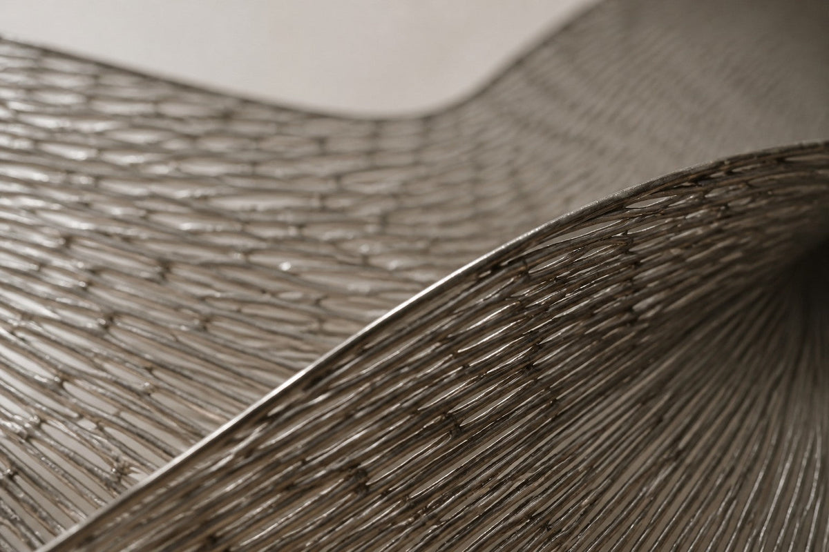 Abadi — 200 × 70 cm brushed steel wire wall sculpture woven into a figure-of-eight loop, close studio detail of the surface and material