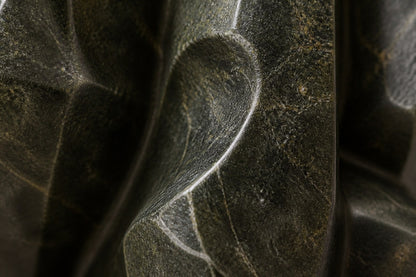 Deep green marble sculpture Almach, a column of stacked interlocking carved blocks on a fluted green marble drum plinth.