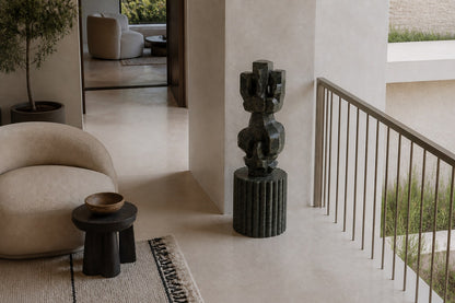 Deep green marble sculpture Almach, a column of stacked interlocking carved blocks on a fluted green marble drum plinth.