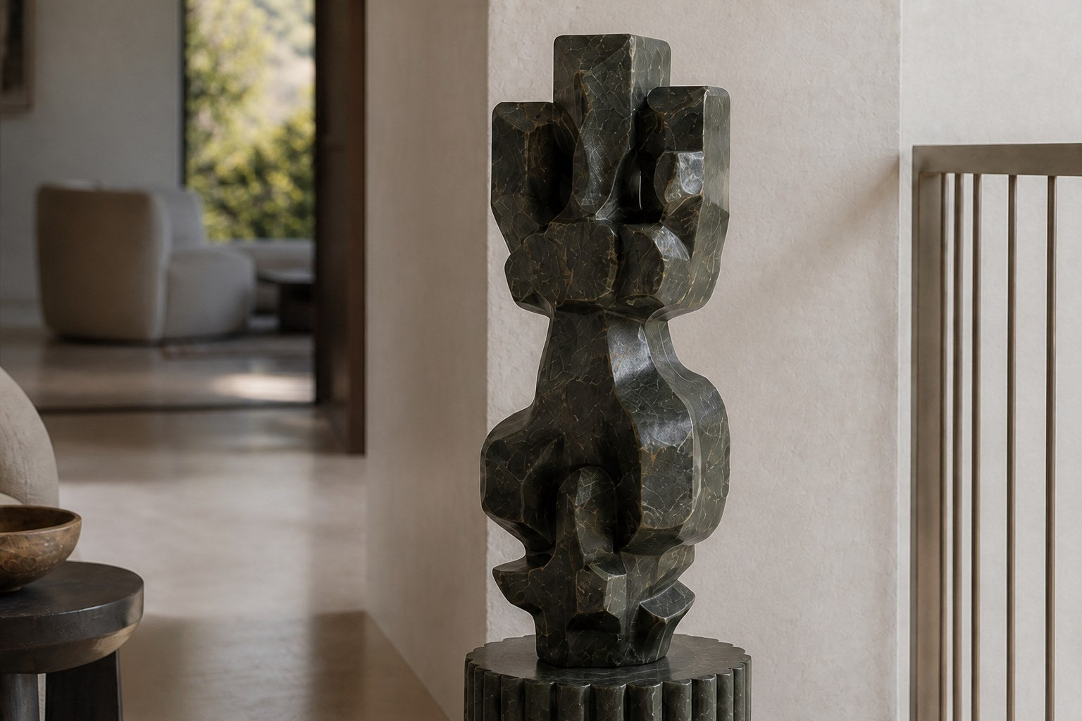 Deep green marble sculpture Almach, a column of stacked interlocking carved blocks on a fluted green marble drum plinth.