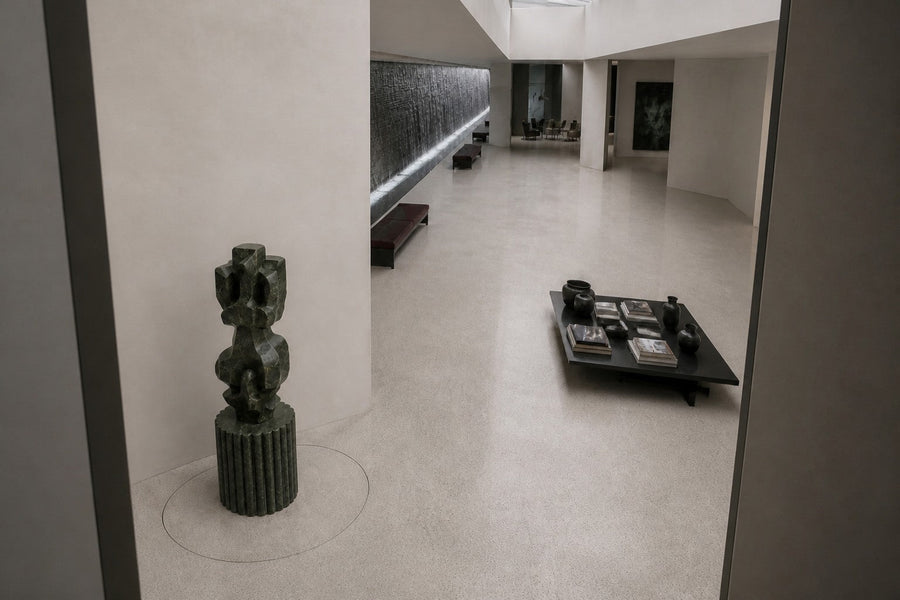Deep green marble sculpture Almach, a column of stacked interlocking carved blocks on a fluted green marble drum plinth.