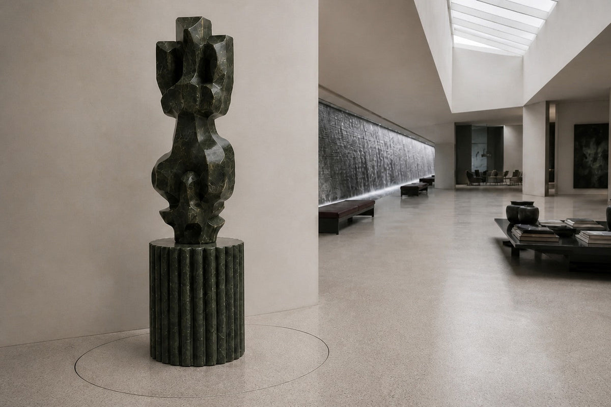 Deep green marble sculpture Almach, a column of stacked interlocking carved blocks on a fluted green marble drum plinth.