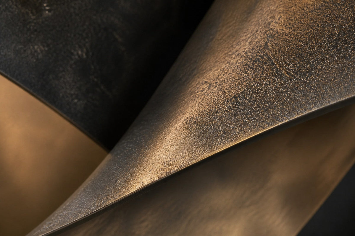 Anello — 140 × 80 cm dark bronze wall sculpture of two linked ribbon loops, close studio detail of the surface and material