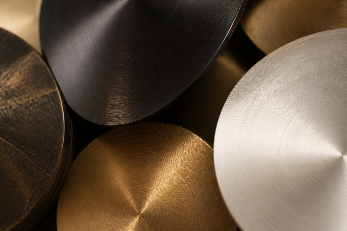 Aqmar — 200 × 80 cm wall cluster of spun discs in black, silver and gold, close studio detail of the surface and material
