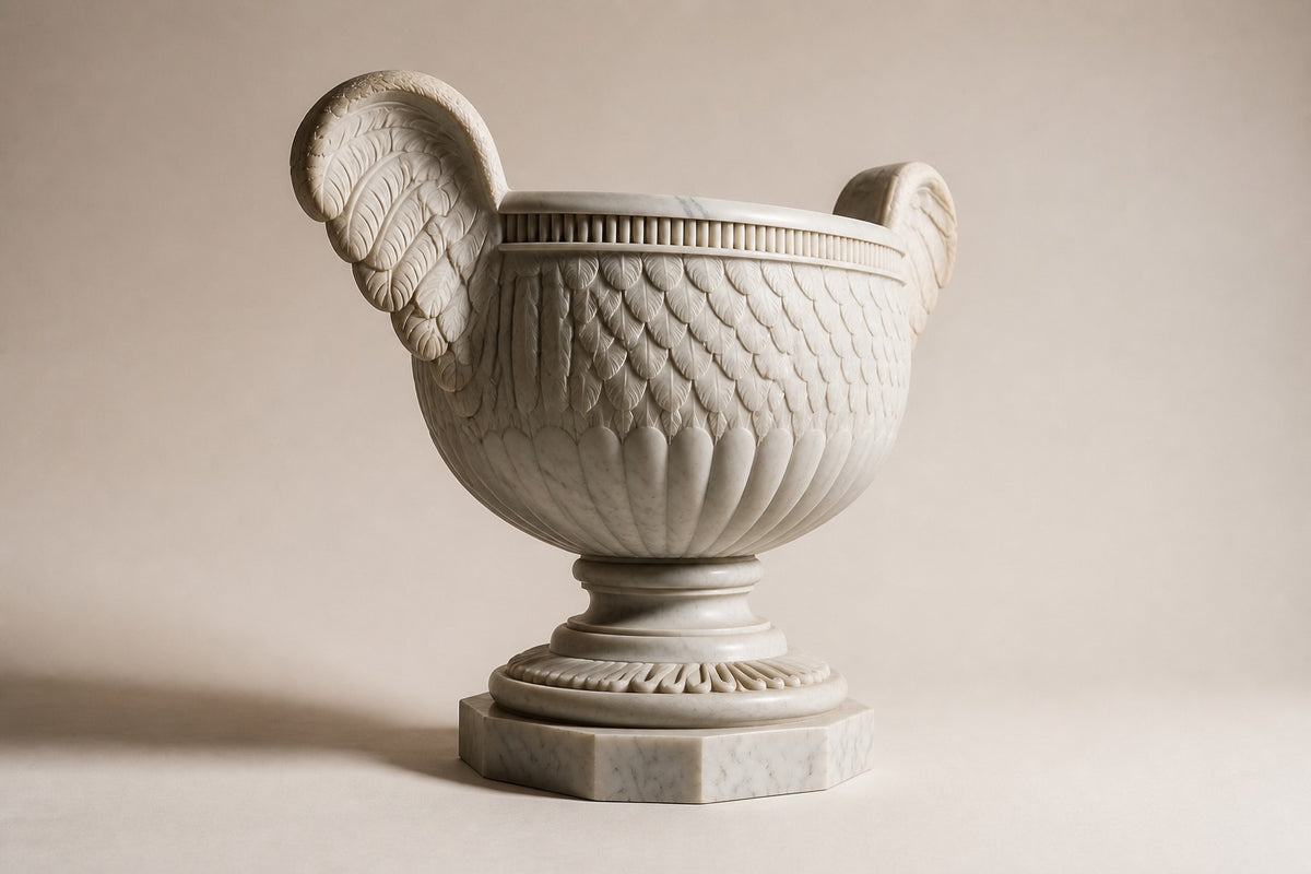 Aquila Wing Marble Urn Planter — 105 cm white Carrara marble urn planter with feather-carved bowl and two carved wing handles, three-quarter studio view showing its profile