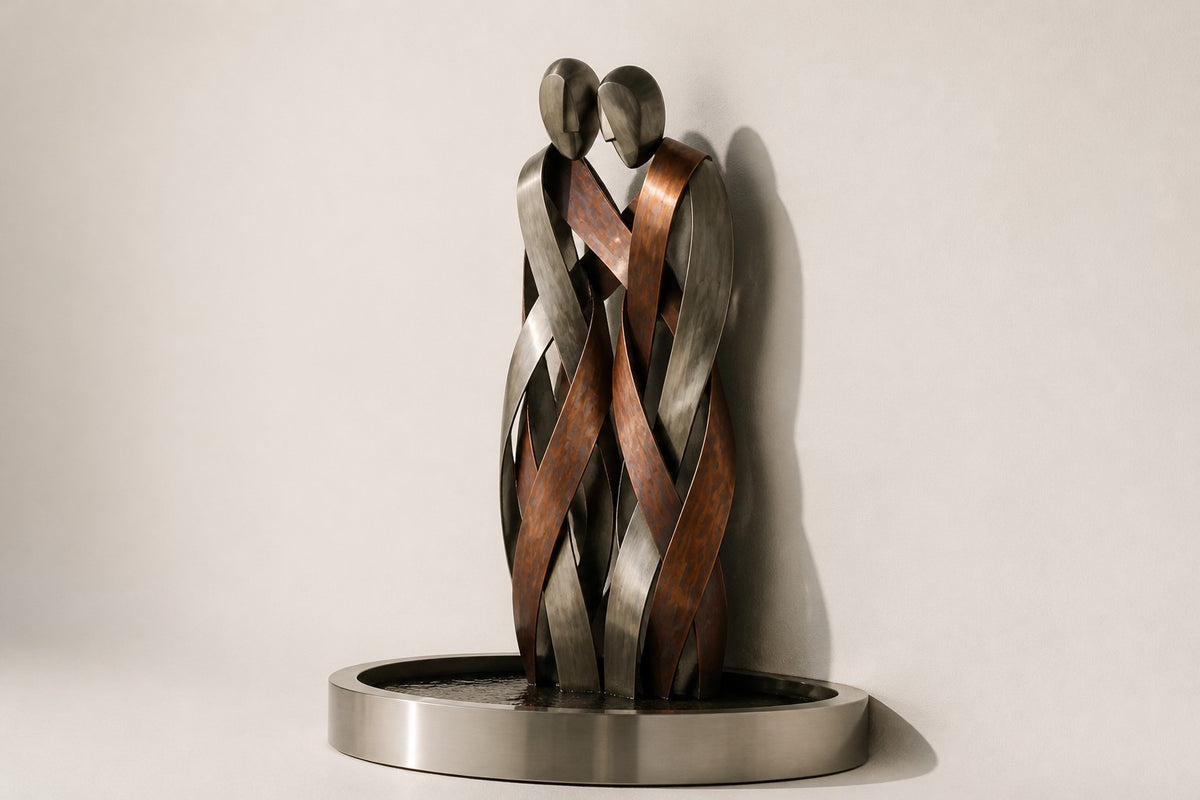 Aria — copper and stainless figures wall fountain, studio side angle showing its depth