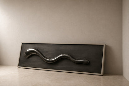 Polished pewter waveform in relief on a dark graphite panel with a pale frame.