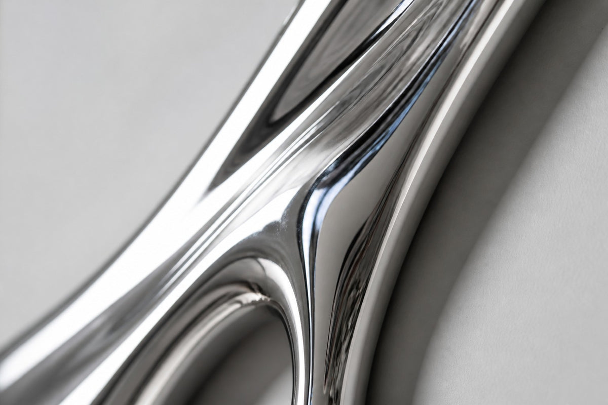 Azogue — mirror-polished stainless steel liquid drip wall sculpture, close detail of the surface and edge
