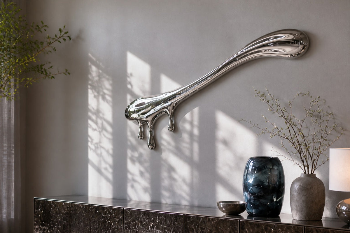 Azogue — mirror-polished stainless steel liquid drip wall sculpture, close view on the wall