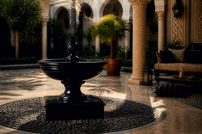 Terrazza black marble tiered fountain by 1-OPH, in a Dubai courtyard setting