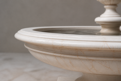 Nemi cream stone tiered fountain by 1-OPH, in a Dubai courtyard setting