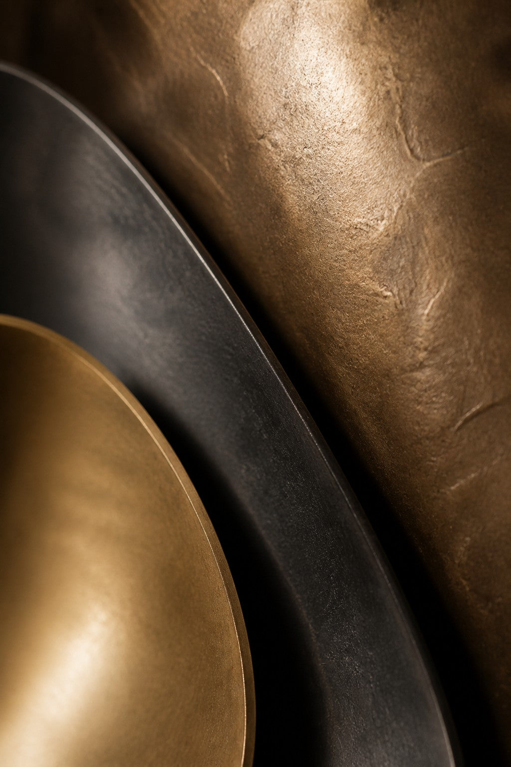Bayda 120 — 120 cm gold and dark bronze oval wall sculpture of nested bowls, close studio detail of the surface and material