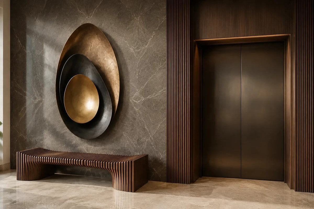 Bayda 120 — 120 cm gold and dark bronze oval wall sculpture of nested bowls, placed in a furnished room