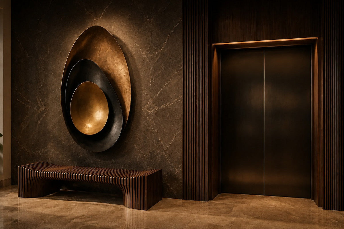 Bayda 120 — 120 cm gold and dark bronze oval wall sculpture of nested bowls, the same room at night, lamps on