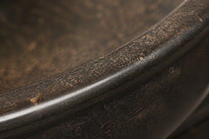 Stone pedestal fountain Brimala Ø65, mottled dark bronze-brown, on a pale stone floor.