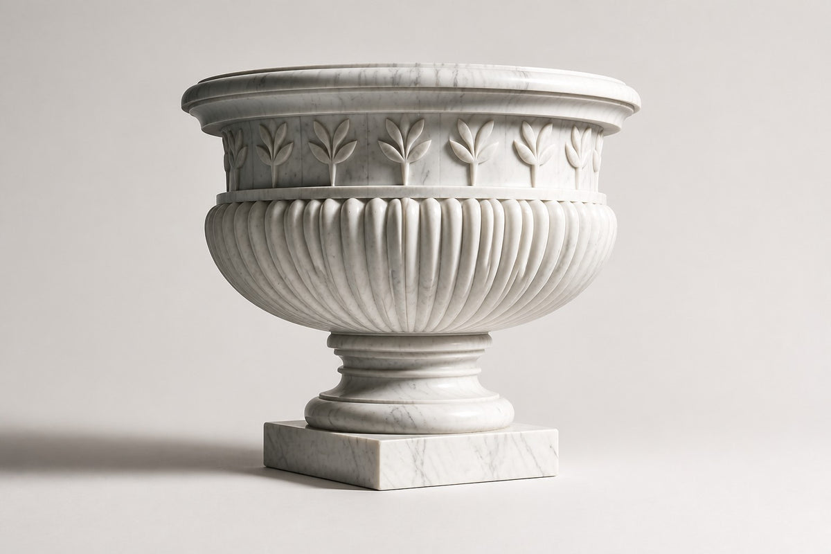 Calacatta Laurel Marble Urn Planter — 80 cm white Calacatta marble urn planter with a laurel-leaf frieze and fluted body, three-quarter studio view showing its profile