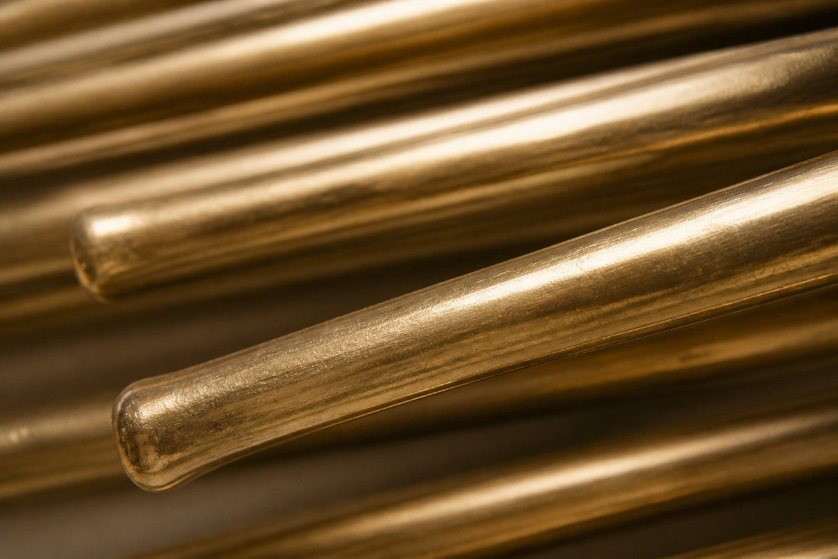 Canaveral — 220 × 40 cm long horizontal sheaf of polished brass rods, close studio detail of the surface and material