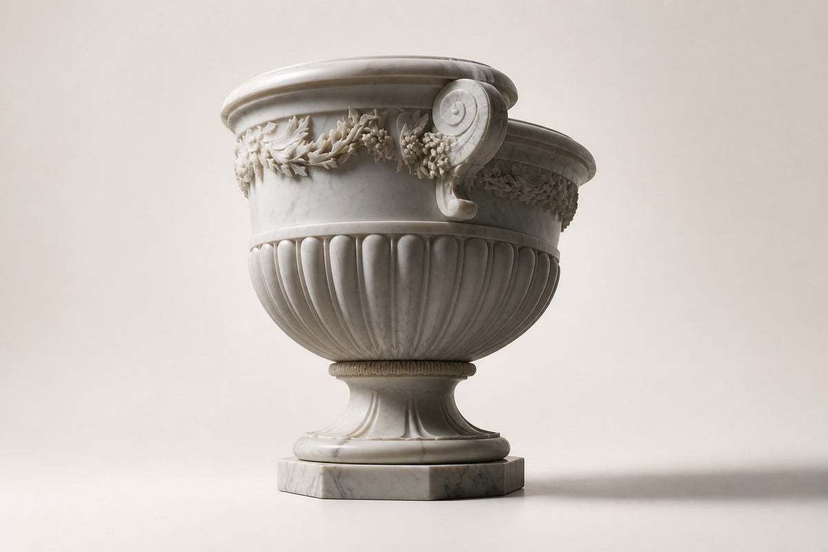 Carrara Floral Garland Marble Urn Planter — 95 cm white Carrara marble urn planter with a carved floral garland and two scroll handles, three-quarter studio view showing its profile