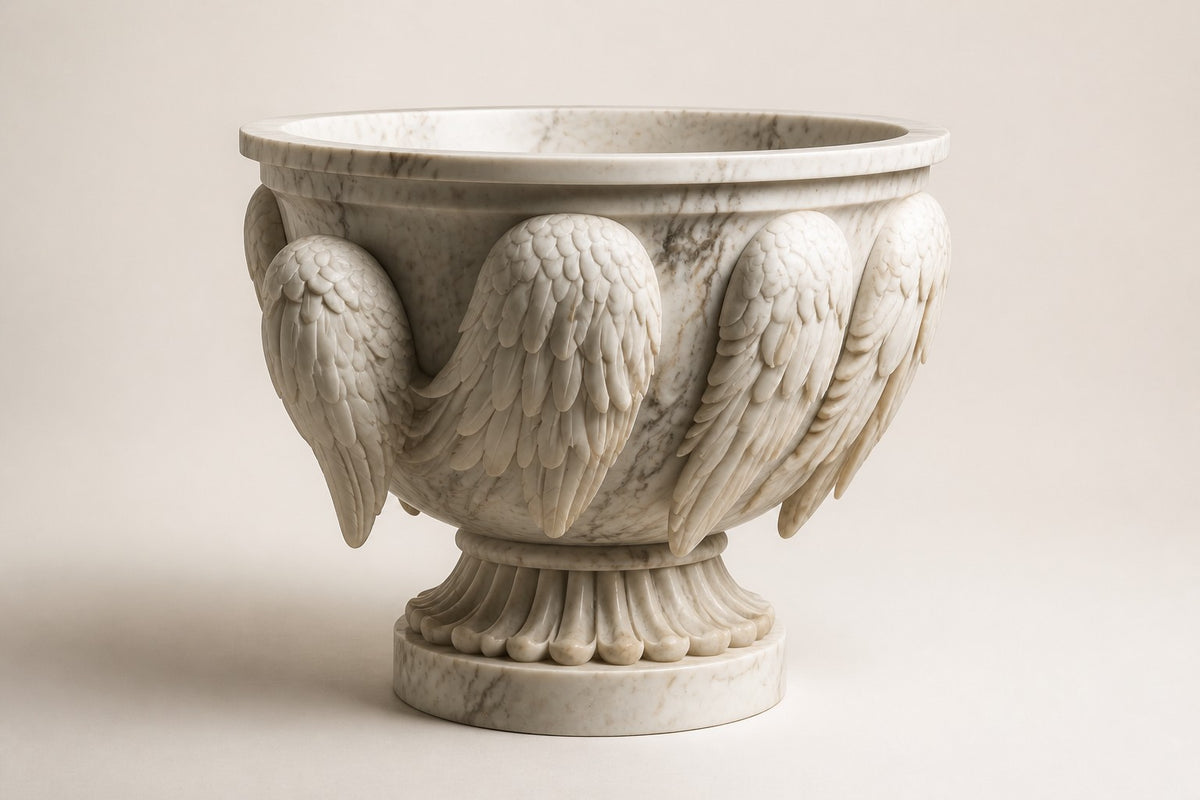 Carrara Winged Marble Urn Planter — 95 cm white Carrara marble urn planter carved with folded wings and an eagle head, three-quarter studio view showing its profile