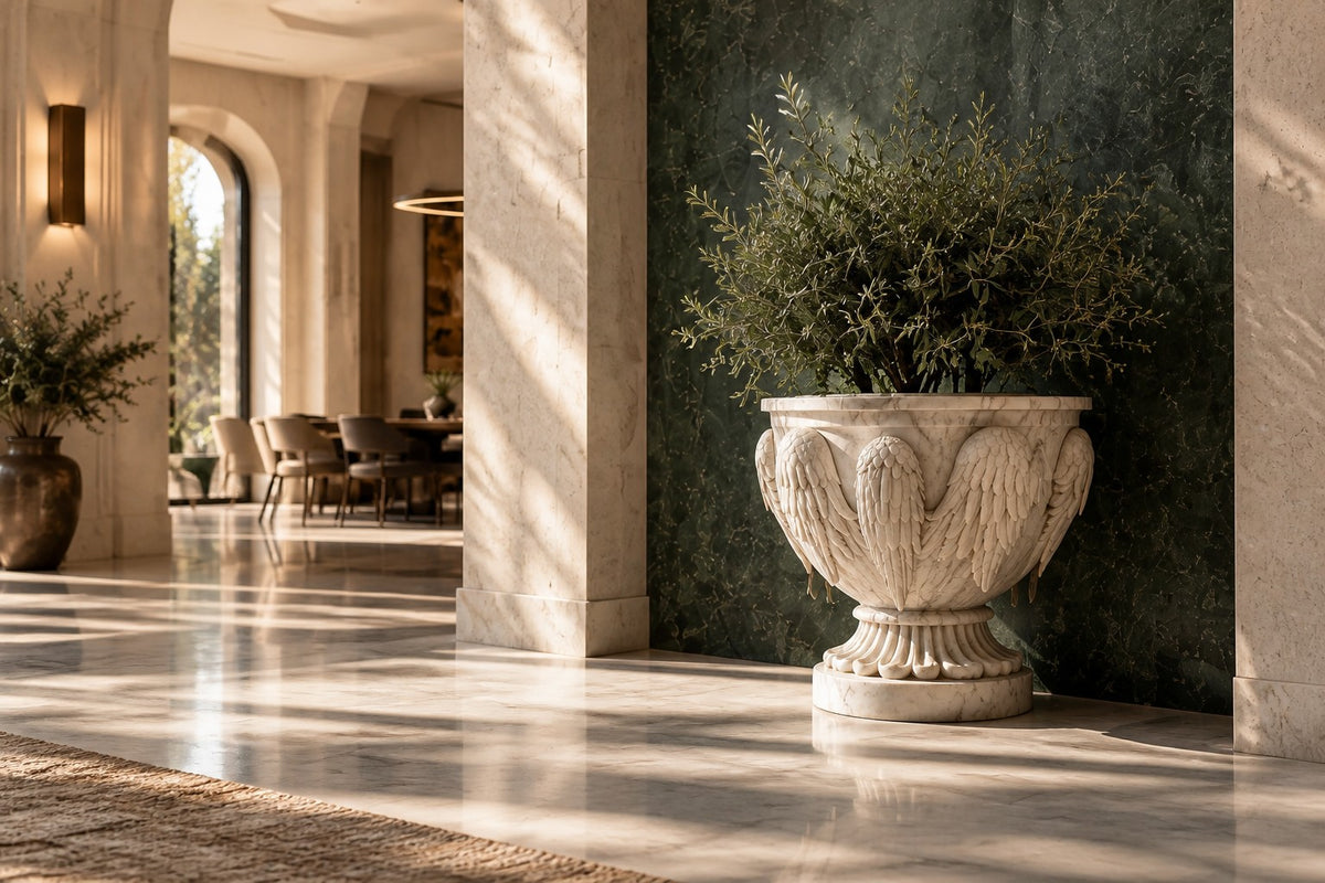 Carrara Winged Marble Urn Planter — 95 cm white Carrara marble urn planter carved with folded wings and an eagle head, close view in the room