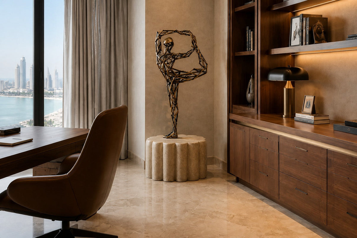 Bronze strut-cage figure sculpture Centina in a backbend on one leg, gilt and blackened, on a fluted travertine drum plinth.