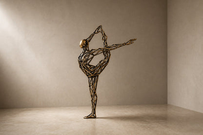 Bronze strut-cage figure sculpture Cesello in arabesque with arm extended, on a dark quilted stone block.
