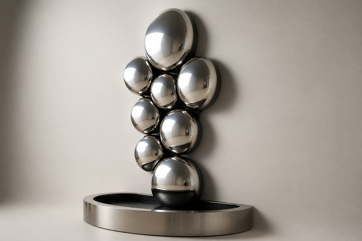 Cirrus — mirror-dome wall fountain, studio side angle showing its depth