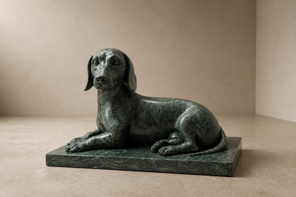 Deep green marble sculpture Collado, a reclining figure carved with its slab base from one block of veined green stone.
